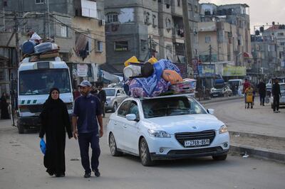 Displaced Palestinians leave Rafah in the southern Gaza Strip with their belongings to safer areas on Tuesday. AFP 