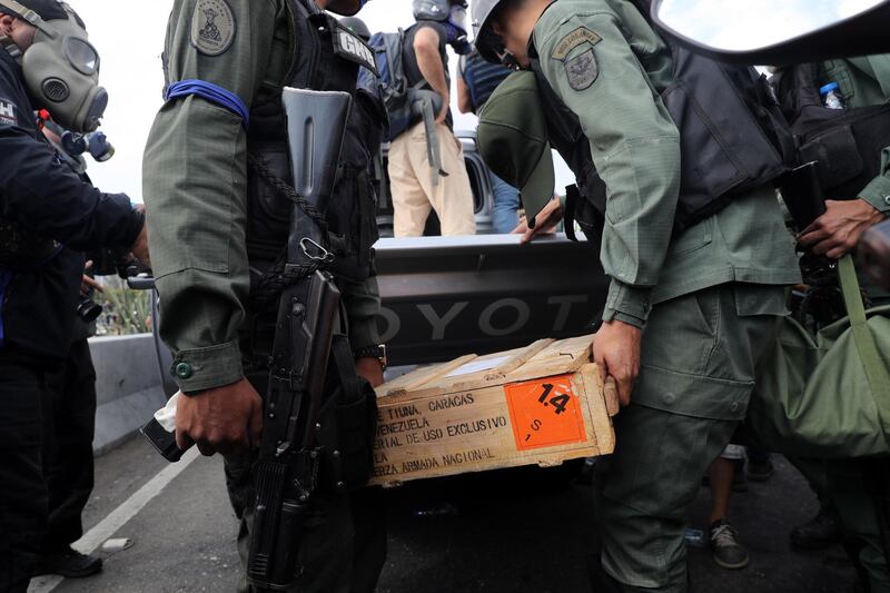 Members of the Bolivarian Armed Forces unload explosive material. EPA