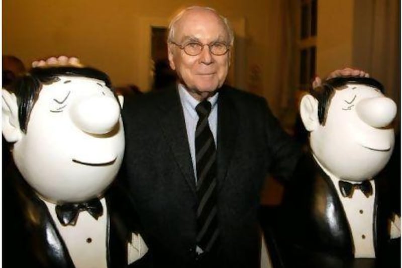 In this 2003 photoraph, German comedian Vicco von Buelow is framed by two of his potato-nosed cartoon figures in Munich.