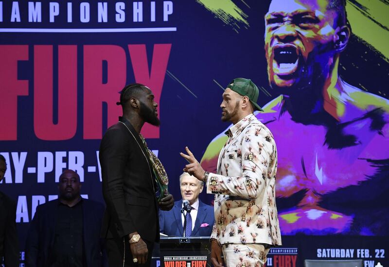Deontay Wilder and Tyson Fury get together during a news conference. AFP