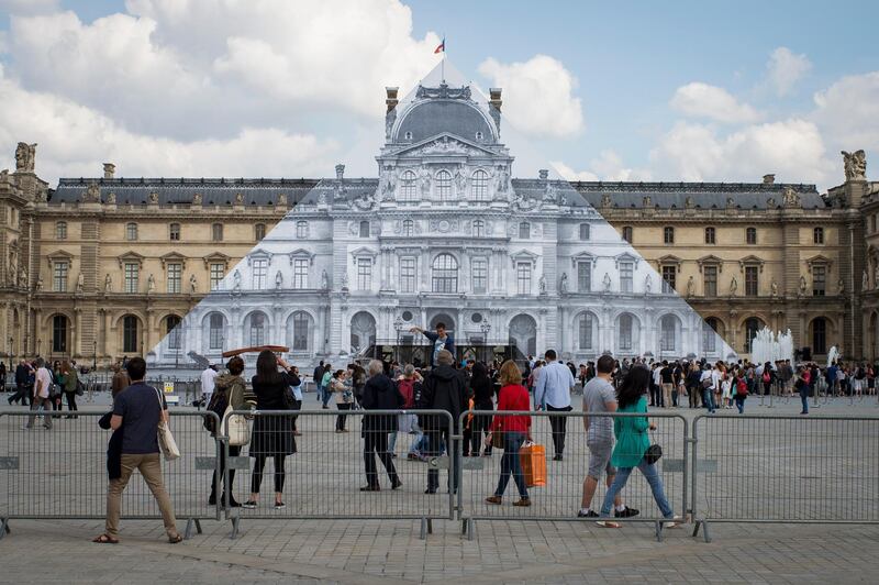 epa07434428 (FILE) A view of the Pyramid of the Louvre museum covered with a gigantic black and white trompe l'oeil photo of the Louvre building by French artist JR in Paris, France, 25 May 2016 (reissued 13 March 2019). Built by US-Chinese architect Ieoh Ming Pei, the Louvre Pyramid celebrates the 30th anniversary of its inauguration, dated 30 March 1989.  EPA-EFE/JEREMY LEMPIN