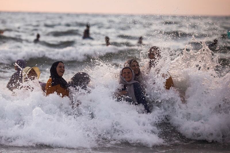 Women enjoy themselves as they bathe in the Mediterranean Sea during the Muslim holiday of Eid al-Adha, in Tel Aviv, Israel.