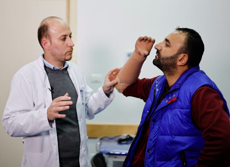 Ahmed Abu Hamda, 36, who lost his right hand in 2007, is shown how to use his new myoelectric limb at the Sheikh Hamad Bin Khalifa Al Thani Rehabilitation and Prosthetics Hospital in the northern Gaza Strip. All photos: Reuters