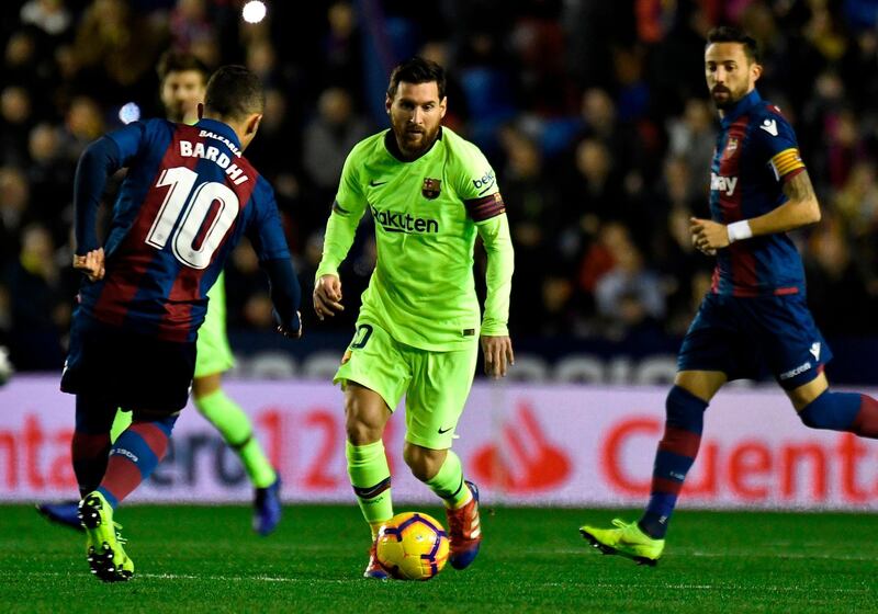 Levante's midfielder Enis Bardhi vies with Lionel Messi. AFP