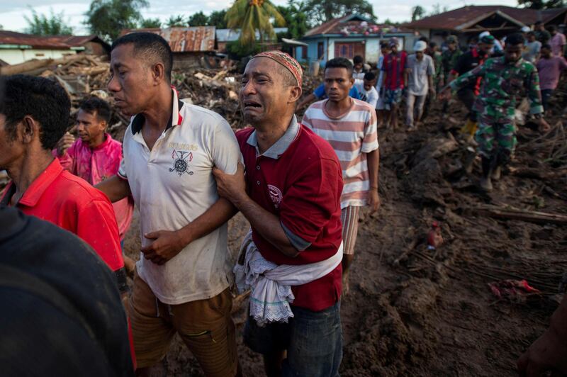 A man is overcome with grief after a relative was found dead following flash floods triggered by a cyclone in East Flores, East Nusa Tenggara province, Indonesia. Reuters