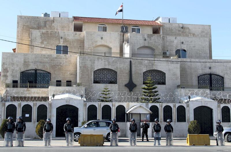 Jordanian riot policemen stand guard outside the Syrian embassy in Amman on December 2, 2011 during a demonstration by Syrians living in Jordan against the Syrian regime and its deadly crackdown on dissidents. AFP PHOTO/KHALIL MAZRAAWI (Photo by KHALIL MAZRAAWI / AFP)