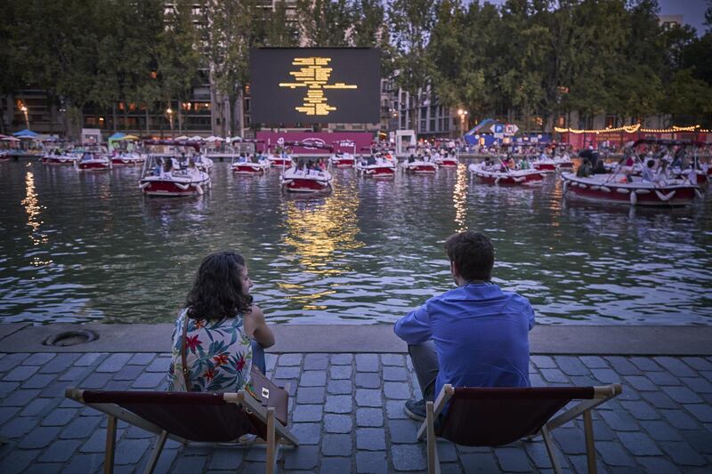 38 electric boats were installed on the Quai de Seine in compliance with social distancing rules, with 150 deckchairs on the banks of the canal, to screen the short film 'Corona Story' by Victor Mirabel, followed by the comedy 'Le Grand Bain', which also included free ice cream.  Getty Images