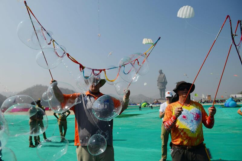 Australian performers make soap bubbles to entertain schoolchildren during the event. AFP