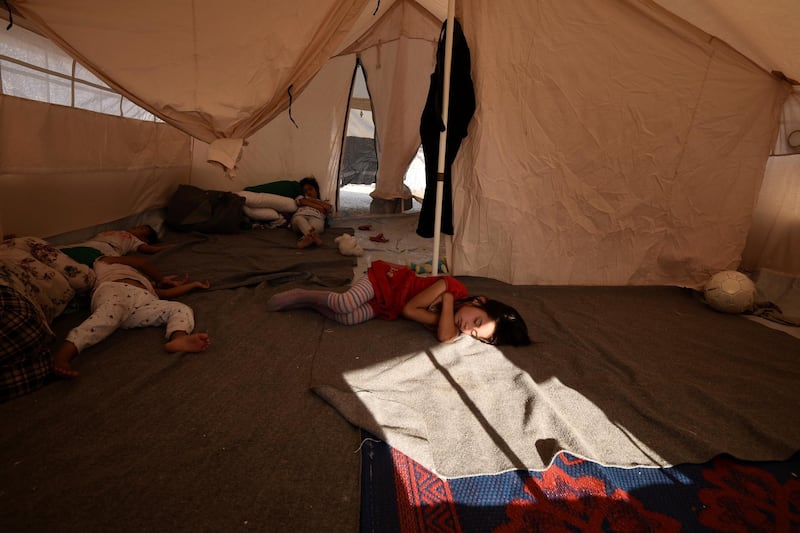 Children sleep inside a tent at a refugee camp in Nea Kavala, northern Greece. About 1,500 asylum-seekers transported from Greece's eastern Aegean island of Lesbos to the mainland. Around 1,000 of those transferred and housed in Nea Kavala, where they will be staying in tents until the end of the month, after which they will be transferred to a new camp under construction.  AP