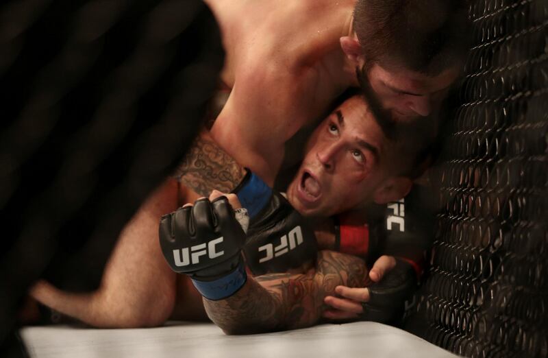 Khabib Nurmagomedov has Dustin Poirier in a choke hold during their fight at UFC 242 on Yas Island. Reuters