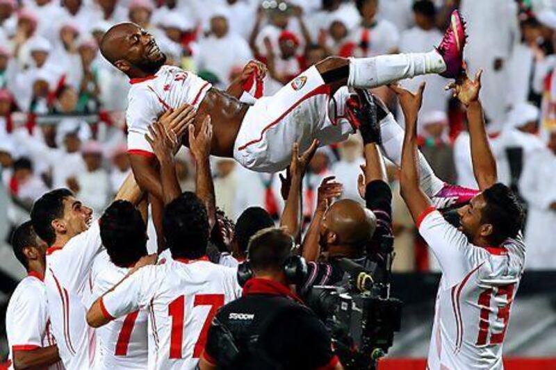 UAE teammates celebrate by tossing Ismail Matar in the air following their 2-1 win over Uzbekistan in an Asian Cup qualifier in Abu Dhabi on Friday night. Satish Kumar / The National