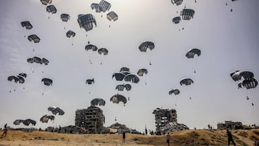 Aid parachuted into northern Gaza. Humanitarian agencies will not want to resort to using private security contractors to help with aid as it could 'militarise' them. AFP