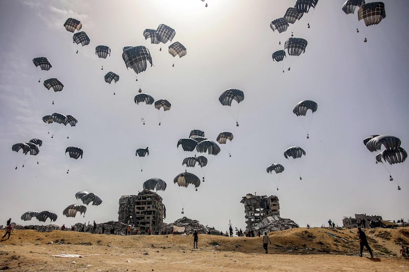 Aid parachuted into northern Gaza. Humanitarian agencies will not want to resort to using private security contractors to help with aid as it could 'militarise' them. AFP