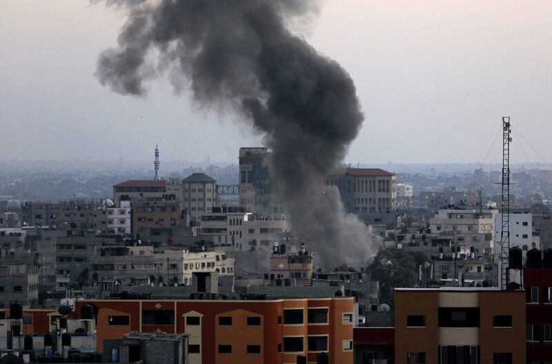 Smoke and dust rise after an Israeli strike hit Gaza City in the northern Gaza Strip on Wednesday. Adel Hana / AP  