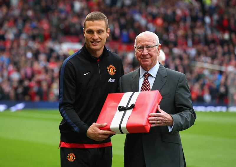 Nemanja Vidic of Manchester United is presented with an award prior to his final home game for the club by Sir Bobby Charlton before Manchester United and Hull City kicked off on Tuesday. Alex Livesey / Getty Images / May 6, 2014