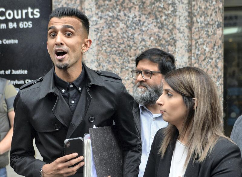 Shakeel Afsar (left) Rosina Afsar and Amir Ahmed (centre) speak to the media outside the Priory Law Courts in Birmingham following a hearing to reconsider an injunction prohibiting anti-LGBT lessons protesters from being in the immediate surroundings of the School.