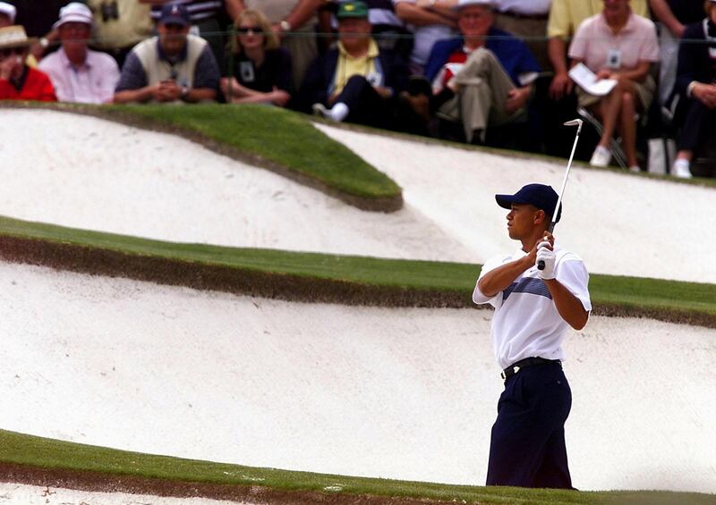 Tiger Woods of the US comes out of a sand trap on the seventh hole at the Augusta National Golf Club, 06 April 2001, during the second round of the 2001 Masters golf tournament in Augusta, Georgia. Garcia started the round at 2 under-par.   AFP PHOTO/Jeff HAYNES (Photo by JEFF HAYNES / AFP)