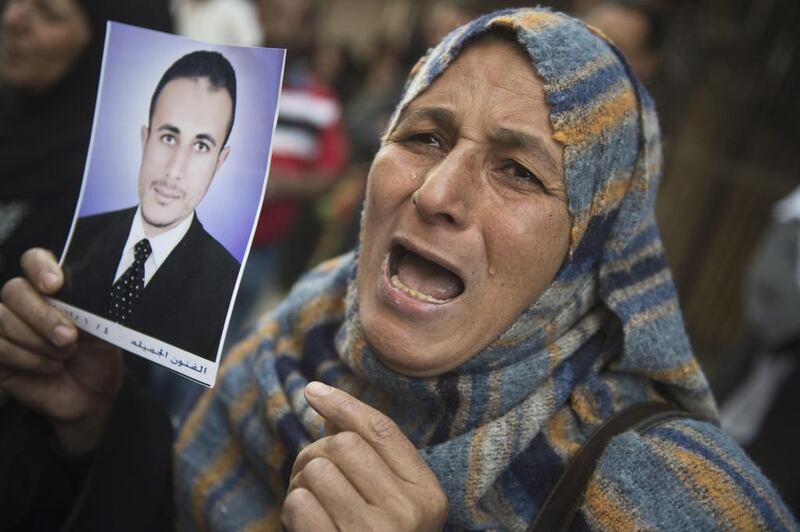 An Egyptian woman holding the portrait of a relative reacts outisde the court that sentenced 682 alleged Islamists and a Muslim Brotherhood leader to death in the southern city of Minya, Egypt. Khaled Desouki / AFP