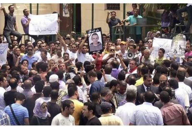 Egyptians shout anti-police slogans during a protest in Alexandria, Egypt. Police are accused of beating a young businessman to death.
