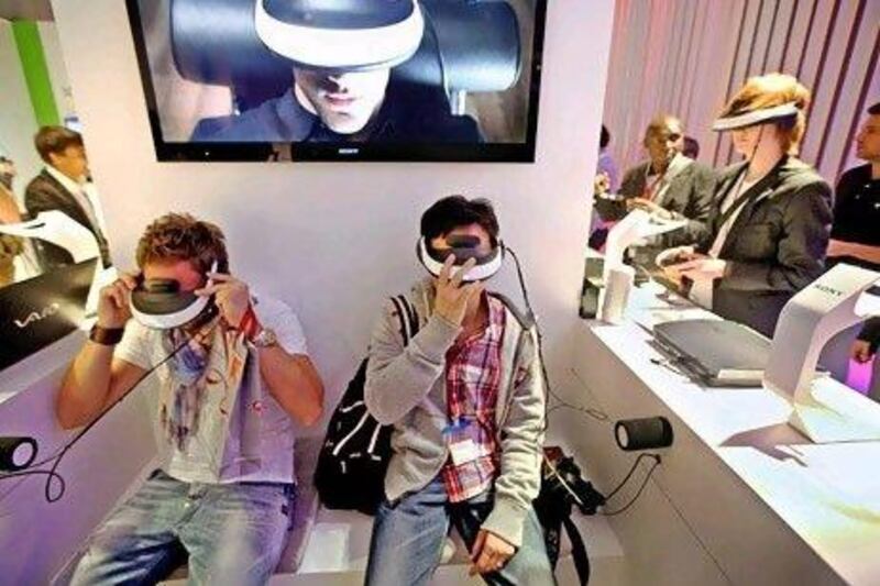 Sony's personal 3-D viewers are now being sold in the UAE. Above, visitors try on Sony's latest gadget in an electronics fair in Berlin. Sean Gallup / Getty Images
