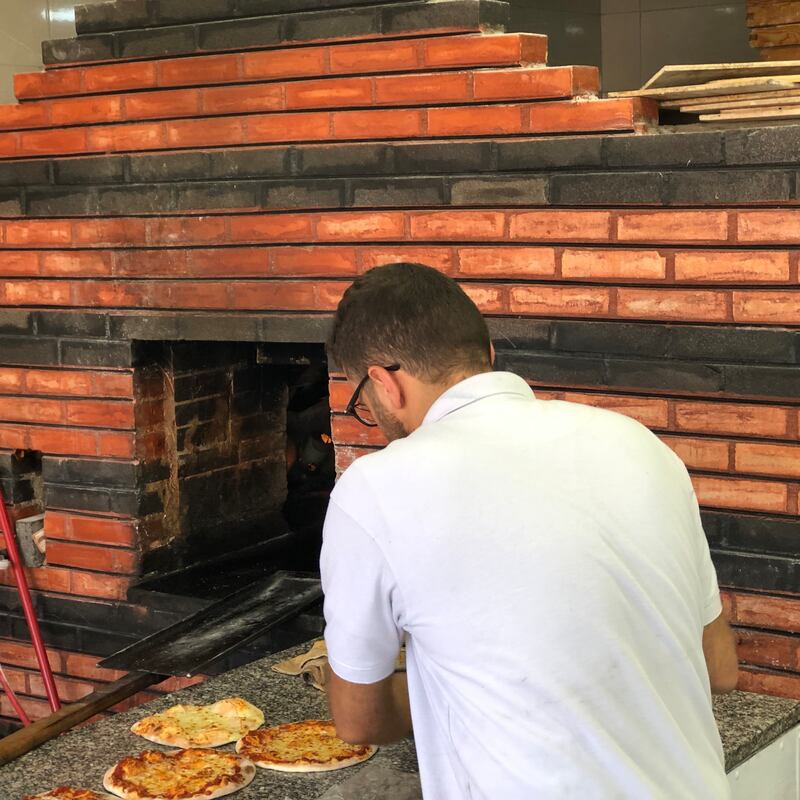 A manakeesh maker at at an oven shop in Yasmin-Badr neighbourhood in Amman