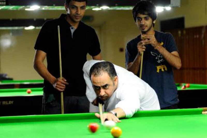 UAE Snooker Team player Mohammed Al Joker pratices at Dubai Snooker Club as follow team members Mohamed Shehab(L) and Khalid Kamali(R) watch on Sunday, June 19, 2011. Photo: Charles Crowell for The National