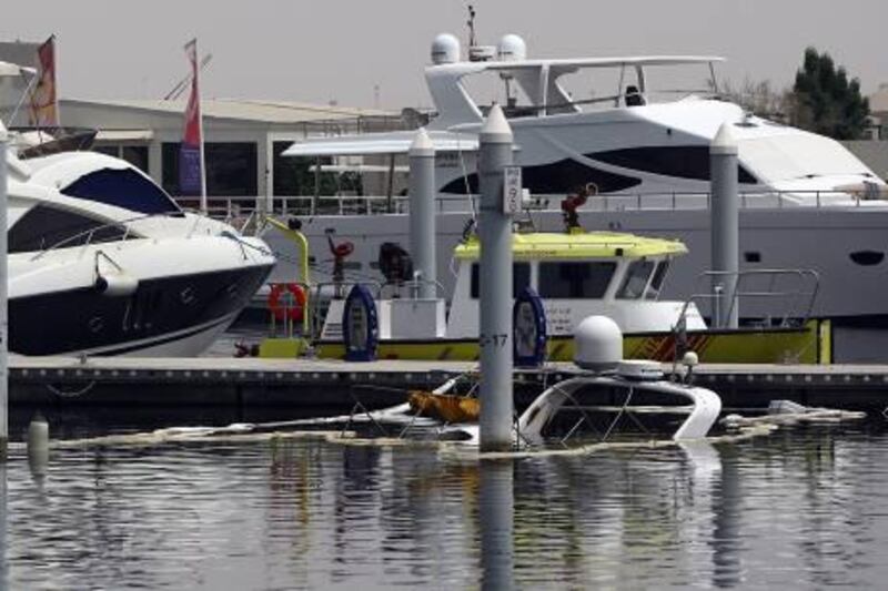 Dubai, United Arab Emirates- July 18,  2011:  Private  Yacht which caught fire last night seen submerged  in Festival city marina  area  in  Dubai.  ( Satish Kumar / The National )