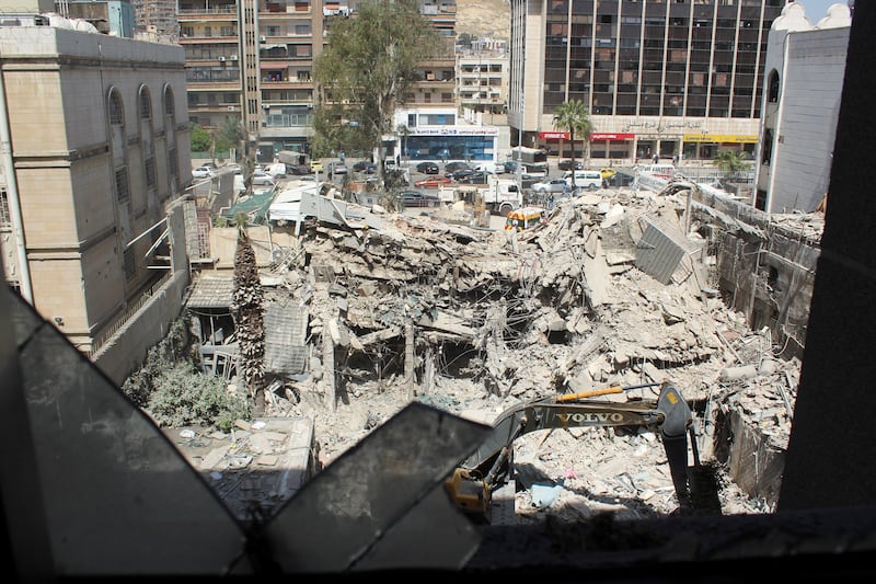 An excavator clears rubble after an Israeli strike on an Iranian embassy annex in Damascus, Syria. Reuters
