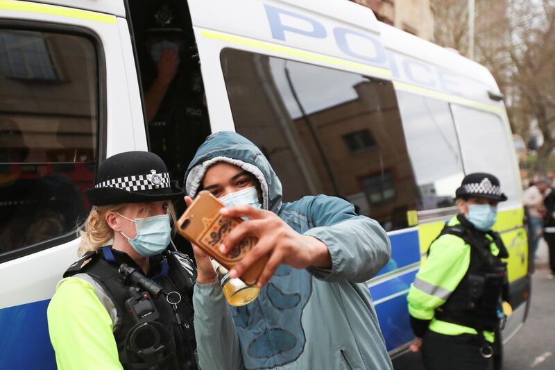 A demonstrator takes a selfie with a police officer in Bristol. Reuters