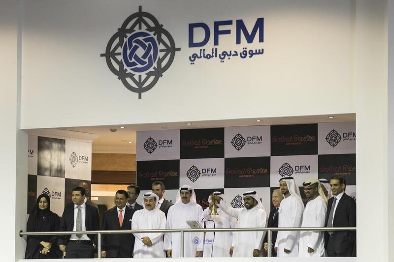Raed Al Nuaimi, the chief executive of Dubai Parks and Resorts, rings the bell to kick off its IPO on the DFM. Reem Mohammed / The National 