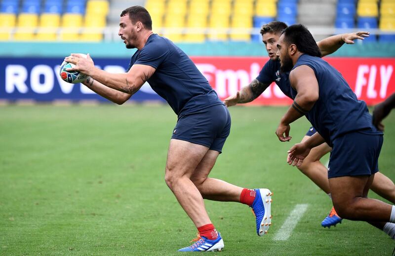 France's number 8 Louis Picamoles (L) runs with a ball during a captain's run training session at the Hakatanomori Stadium in Fukuoka on the eve of their Japan 2019 Rugby World Cup Pool C match against the United States. AFP