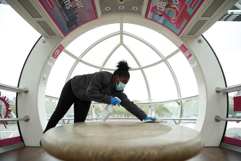 A member of staff cleans a pod of the London Eye in preparation for its reopening, as coronavirus disease restrictions ease in the UK. Reuters