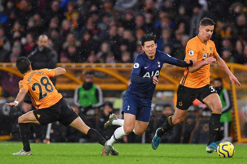 Wolverhampton Wanderers midfielder Joao Moutinho (L) is booked for this foul on Tottenham Hotspur's Son Heung-min. AFP