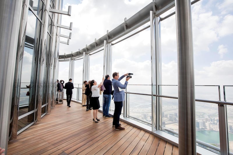 DUBAI, UNITED ARAB EMIRATES - Media people get the first glimpse of the 152 open deck of The Lounge at the unveiling of The Lounge at Burj Khalifa.  Leslie Pableo for The National