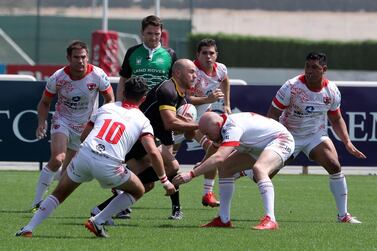 Dubai Tigers, in white, quell an Al Ain Amblers attack on their way to winning the UAE Conference title. Pawan Singh / The National