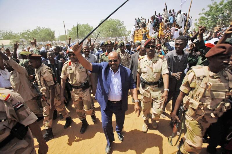 Omar Al Bashir, the Sudanese president, centre, waves to the crowd during a visit to Al Daein in Eastern Darfur. Mr Al Bashir told The National that the Darfur conflict is 'weeks away' from ending. Ashraf Shazly / AFP Photo