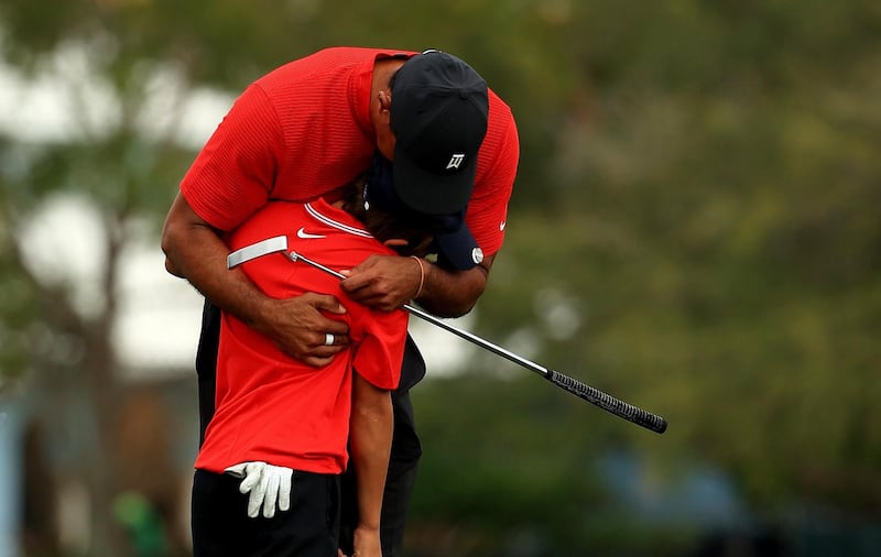 Tiger Woods and son Charlie hug on the 18th hole during the final round of the PNC Championship at the Ritz Carlton Golf Club. AFP