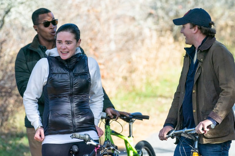 Naomi Biden and Peter Neal, stop their bikes in Nantucket, Massachusetts, for her grandfather President Joe Biden and his wife Dr Jill Biden to pass in a motorcade.  AP