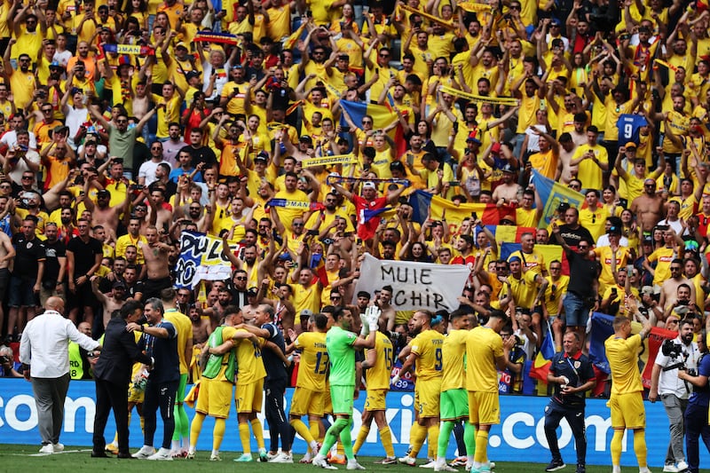 Players of Romania celebrate with their supporters after winning the Group E match against Ukraine. EPA