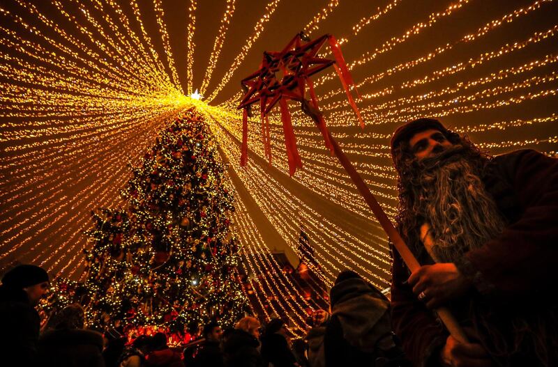 An actor performs near Red Square decorated for the New Year and Christmas holidays in the center of Moscow, Russia.  EPA