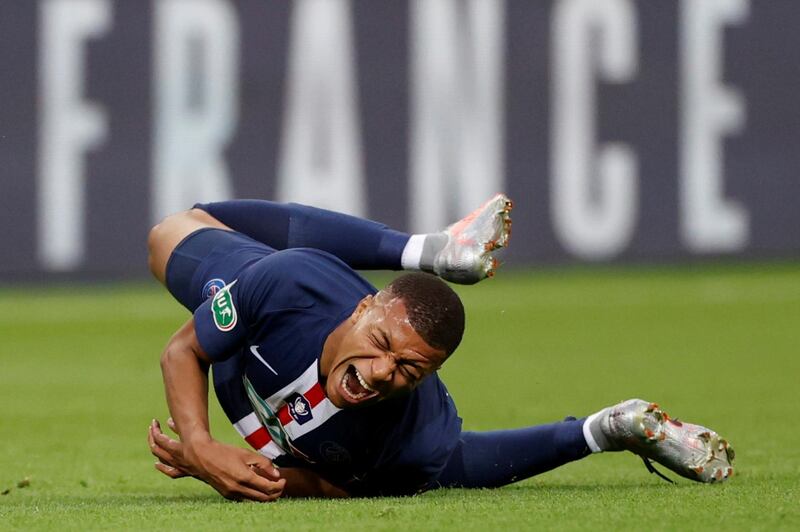 Kylian Mbappe goes down injured for PSG in the French Cup final.  Reuters