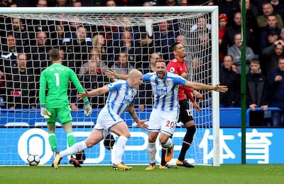 Huddersfield Town's Aaron Mooy, center, celebrates scoring his side's first goal of the game during the English Premier League soccer match between Huddersfield Town and Manchester United at the John Smith��������s stadium in Huddersfield, England. Saturday, Oct. 21, 2017. (Nigel French/PA via AP)