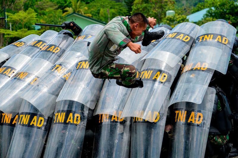 Indonesian soldiers in Banda Aceh take part in riot training ahead of elections. AFP