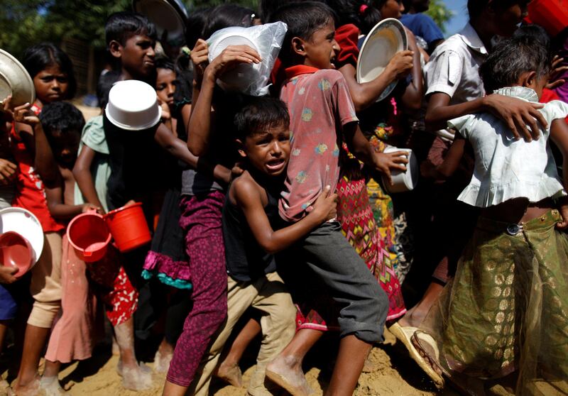 A Rohingya refugee boy cries as he jostles with others queuing to receive food outside the distribution centre in the Palongkhali camp in Cox's Bazar, Bangladesh. Navesh Chitrakar / Reuters