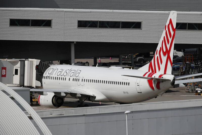 FILE PHOTO: A Virgin Australia Airlines plane is seen at Kingsford Smith International Airport the morning after Australia implemented an entry ban on non-citizens and non-residents intended to curb the spread of the coronavirus disease (COVID-19) in Sydney, Australia, March 21, 2020.  REUTERS/Loren Elliott/File Photo