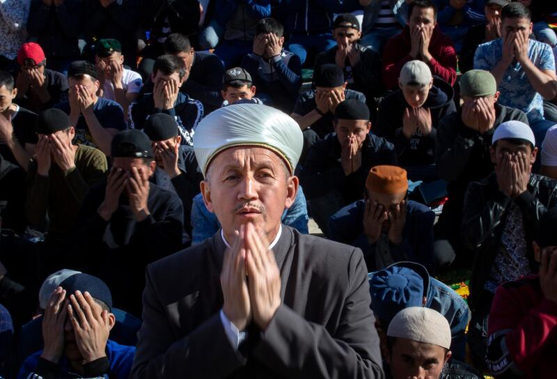 A mufti and other Muslims pray outside the Moscow Cathedral Mosque during celebrations of Eid Al Fitr in Moscow, Russia. AP Photo
