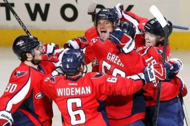 Alex Ovechkin, centre, is mobbed by teammates after his early goal helped lead the Washington Capitals over the Rangers and sent the series back to New York for Game 7.