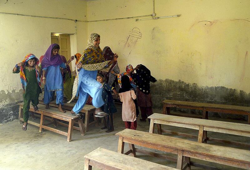 Pakistani children try teach one another or play in classrooms that have been abandoned by teachers. Riswan Tabassum / AFP 