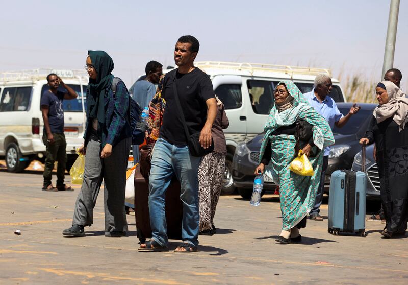 Passengers fleeing from Sudan arrive at the Argeen land port. Reuters