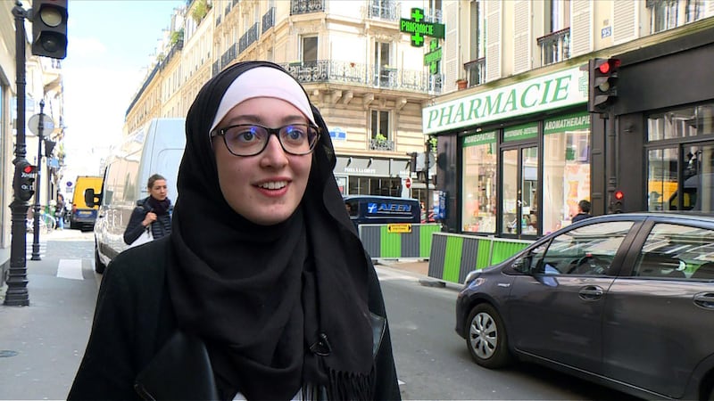 In this video grab image taken on May 2, 2018, Union President at Paris-Sorbonne University (Paris IV) Maryam Pougetoux walks down a street in Paris. - UNEF - a student union is facing criticism after electing to its leadership a veiled Muslim woman. (Photo by STR / AFP)